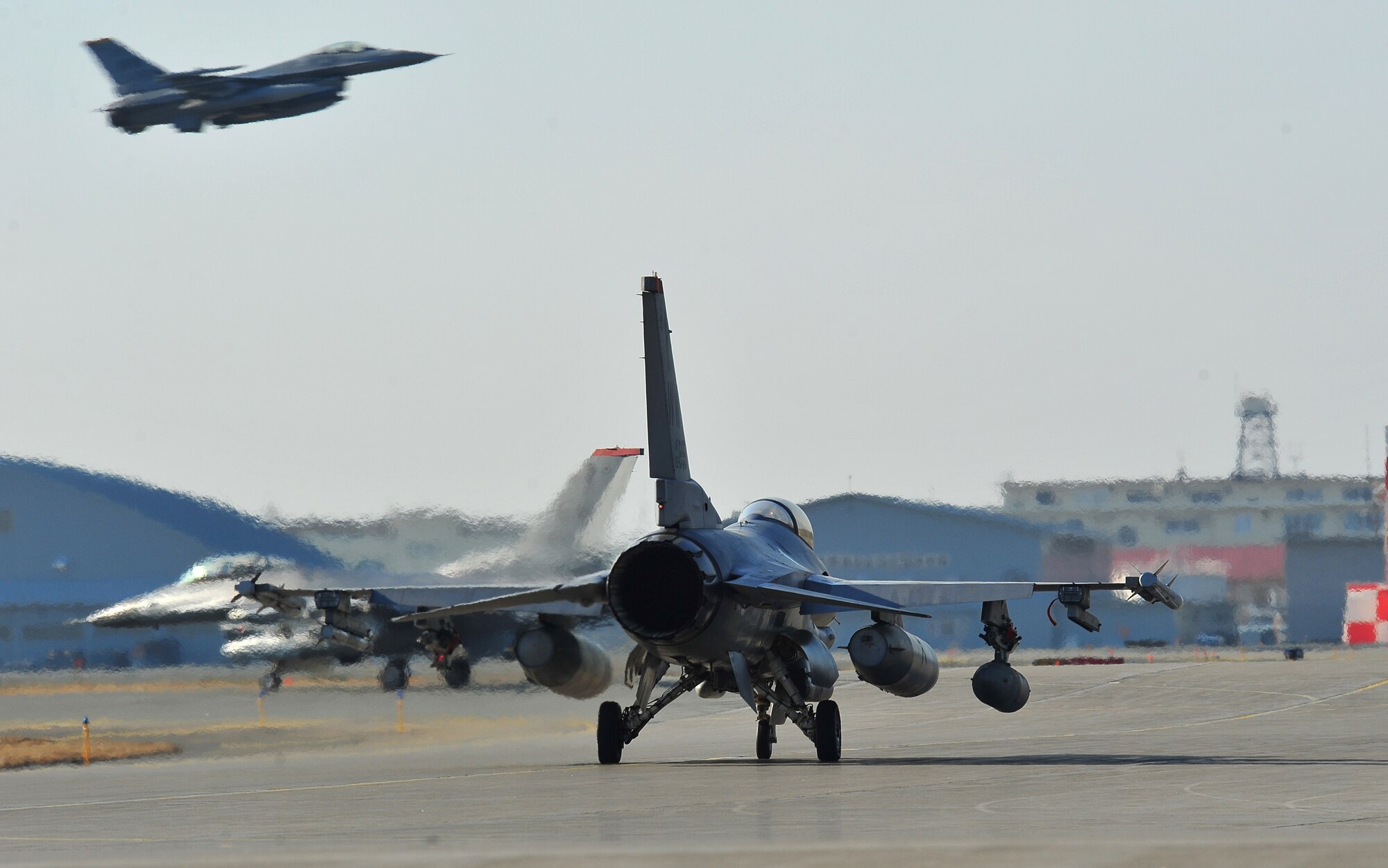 A group of F-16 Fighting Falcons at Misawa Air Base, Japan, taxi down the runway as they ready for deployment April 8, 2014. Pilots from the 13th Fighter Squadron will be providing support to combatant commanders down range. (U.S. Air Force photo/Senior Airman Jose L. Hernandez-Domitilo)