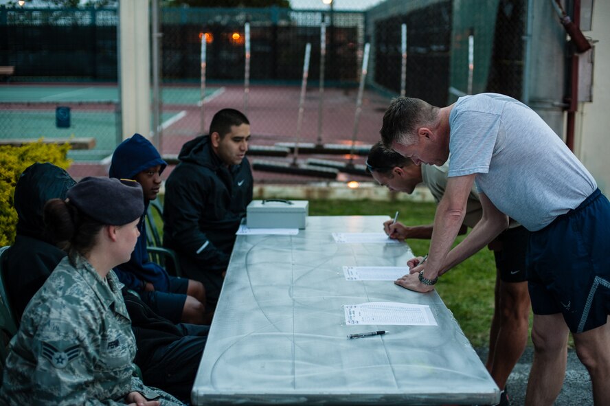 Participants sign in before the start of the Air Force Assistance Fund 6.5K Habu Run on Kadena Air Base, Japan, April 4, 2014. Volunteers for the event collected $468 in donations from the runners for the AFAF. (U.S. Air Force photo by Staff. Sgt. Alexy Saltekoff)