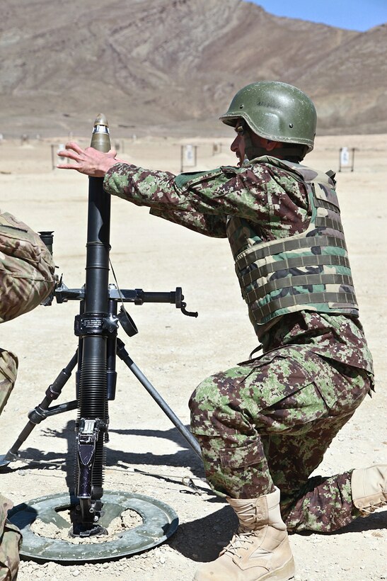 Afghan Army Staff Sgt. Ayam Mudin fires a mortar during a training exercise on Forward Operating Base Thunder in Afghanistan's Paktia province, April 7, 2014. Mudin is assigned to the Regional Military Training Center.