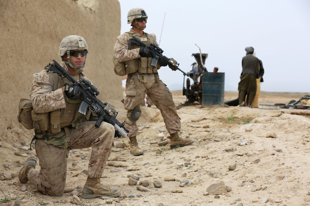 U.S. Marine Corps Cpl. Juan Urena and U.S. Marine Corps Lance Cpl. Peter Vazquez provide security during a patrol in Helmand province, Afghanistan, March 27, 2014. Urena, a squad leader, and Vazquez, a rifleman, are assigned to Bravo Company, 1st Battalion, 9th Marine Regiment, and patrolled with Afghan soldiers as part of their transition in becoming the primary security force in the area.
