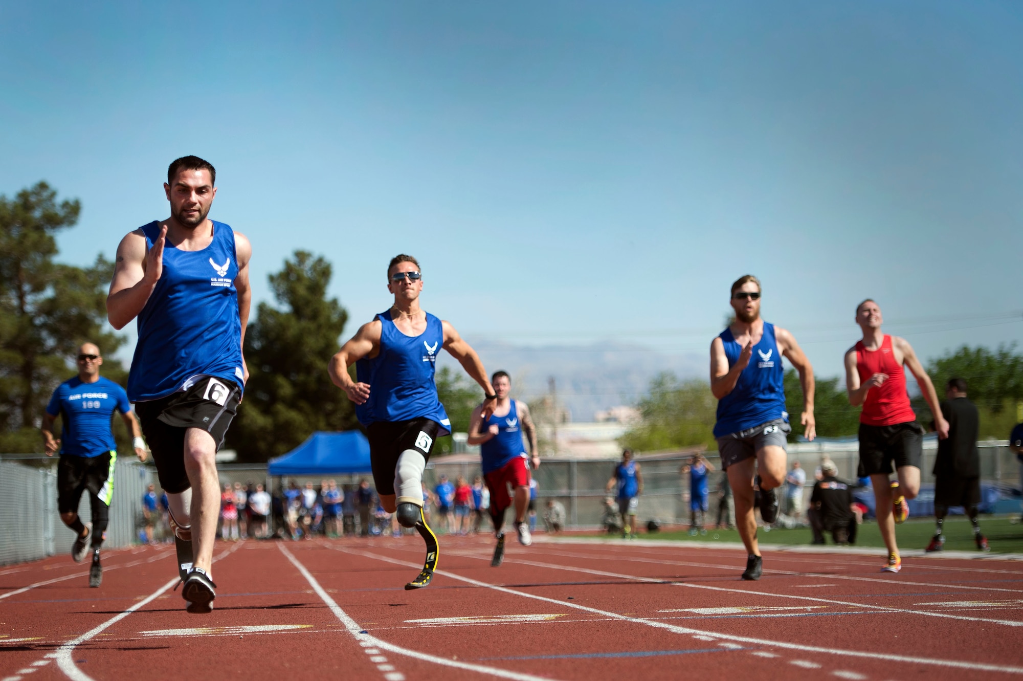 Airmen race to the finish line during the track and field portion of the Air Force Trials April 8, 2014, at Rancho High School in Las Vegas, Nev. The Air Force Trials give injured, ill and wounded Airmen a chance to compete in Paralympic-style events.  (U.S. Air Force photo/Senior Airman Jette Carr)