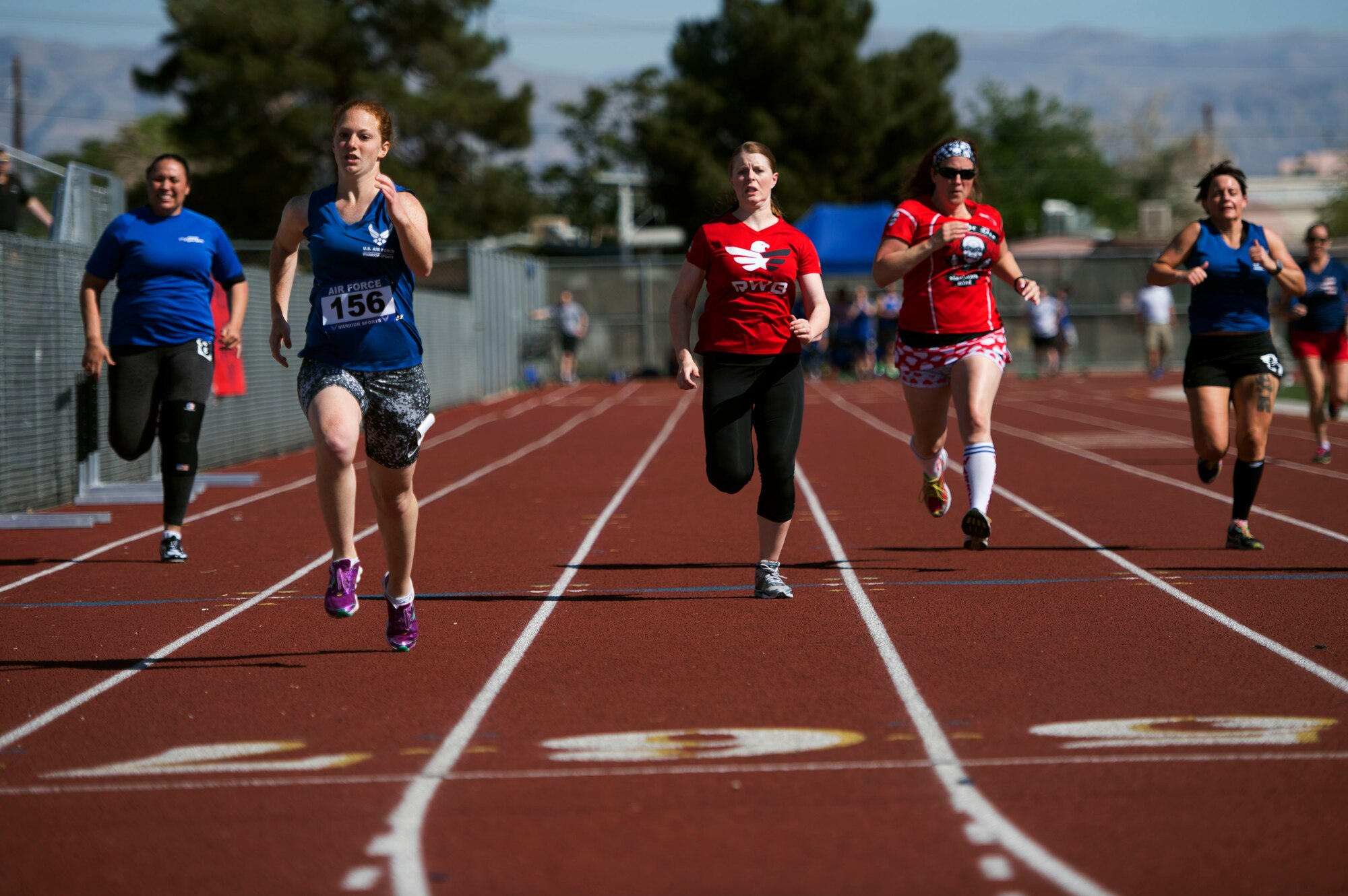 Airmen race to the finish line during the track and field portion of the Air Force Trials April 8, 2014, at Rancho High School in Las Vegas, Nev. The Air Force Trials give injured, ill and wounded Airmen a chance to compete in Paralympic-style events.  (U.S. Air Force photo/Senior Airman Jette Carr)
