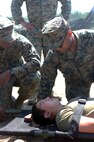 Petty Officer Second Class Fabian Andrini, a hospital corpsmen with 2nd Medical Battalion, Combat Logistics Regiment 25, 2nd Marine Logistics Group, speaks to a sailor with a simulated injury to gauge his alertness and keep him conscious during a medical field exercise aboard Camp Lejeune, N.C., April 2, 2014. Corpsmen provide emergency medical treatment on battlefields and ensure the wellbeing of service members in deployed and garrison environments. 