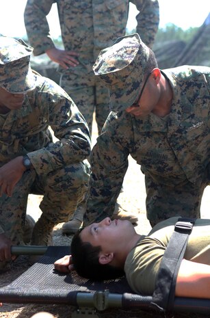 Petty Officer Second Class Fabian Andrini, a hospital corpsmen with 2nd Medical Battalion, Combat Logistics Regiment 25, 2nd Marine Logistics Group, speaks to a sailor with a simulated injury to gauge his alertness and keep him conscious during a medical field exercise aboard Camp Lejeune, N.C., April 2, 2014. Corpsmen provide emergency medical treatment on battlefields and ensure the wellbeing of service members in deployed and garrison environments. 