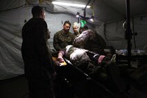 Hospital corpsmen with 2nd Medical Battalion, Combat Logistics Regiment 25, 2nd Marine Logistics Group prepare a service member with a simulated injury for surgery during a medical field exercise aboard Camp Lejeune, N.C., April 2, 2014. The battalion completed the exercise to train in a manner similar to deployed environments.