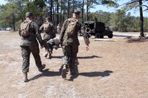 Hospital corpsmen with 2nd Medical Battalion, Combat Logistics Regiment 25, 2nd Marine Logistics Group carry a service member with a simulated injury to a medical evacuation vehicle during a field exercise aboard Camp Lejeune, N.C., April 2, 2014. The corpsmen trained for the care and treatment of casualties from reception until they were able to send the wounded to a higher level of care.