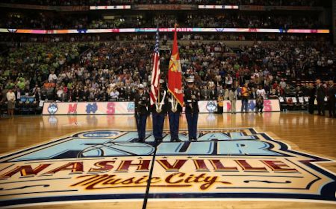 Nashville Marines honor the American flag as the attending color guard at the Women's Final Four semifinal game between Notre Dame and Maryland at the Bridgestone Arena in Nashville, Tennessee, April 6, 2014. Marines are partnering with the Women's Basketball Coaches Association and their national convention timed to coincide with the NCAA Women's Basketball Tournament.
