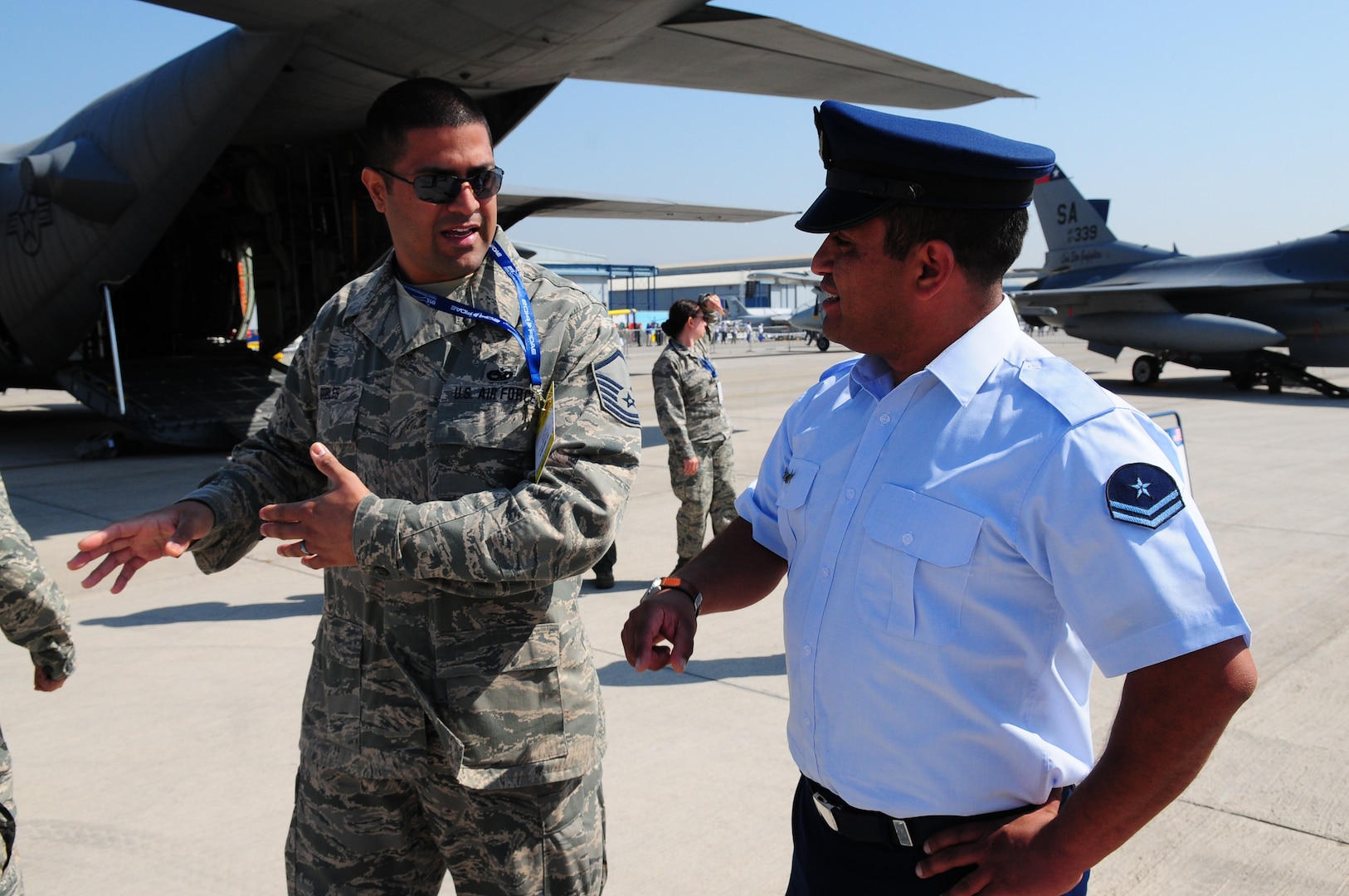 Master Sgt. Stephen Dobles, an aircraft maintenance technician with the 149th Fighter Wing, Texas Air National Guard, exchanges maintenance practices with his counterpart with the FACH (Fuerza Aerea de Chile) during FIDAE (Feria Internacional del Aire y del Espacio), an international trade air and space show, in Santiago, Chile, March 26, 2014. Members of the Texas Air National Guard were in Chile as part of the National Guard Bureau's State Partnership Program. 