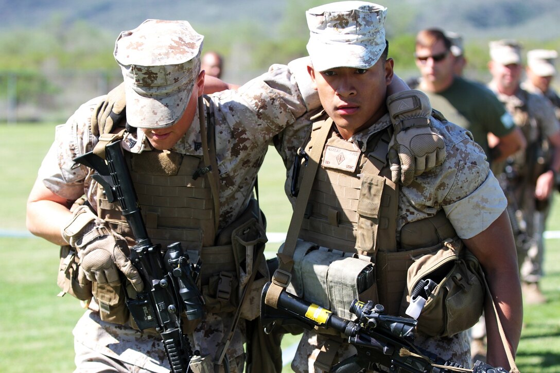 Corporal Arnold Alejo, right, a combat engineer with 1st Marine Division, 1st Combat Engineer Battalion, practices moving casualties during the Division Schools Urban Leader Course aboard Marine Corps Base Camp Pendleton, Calif., April 3, 2014. The Marines practiced assaulting buildings and recovering hostages in addition to the proper tactics and skills that are essential for success in urban combat. (U.S. Marine Corps photo by Lance Cpl. Joshua Murray/released)

