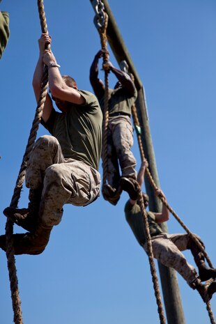 Marines attending 2nd Marine Logistics Group’s Corporal’s Course at Camp Lejeune, N.C., climb ropes at the end of an obstacle course March 20, 2014. Earlier in the day, the Marines conducted sword and guidon training as part of the courses multi-faceted curriculum.