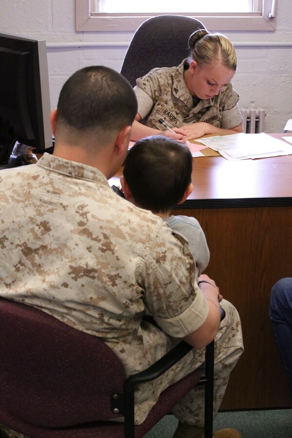 Lance Cpl. Vicki Harris, an administrative specialist, helps a family prepare their taxes at the Quantico Tax Center aboard Marine Corps Base Quantico on April 2, 2014. The tax center offers free tax preparation assistance to Marines, family members and military retirees. 