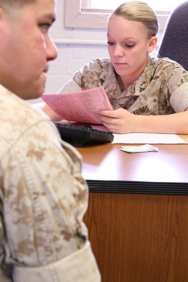 Lance Cpl. Vicki Harris, an administrative specialist, helps a family prepare their taxes at the Quantico Tax Center aboard Marine Corps Base Quantico on April 2, 2014. The tax center offers free tax preparation assistance to Marines, family members and military retirees.