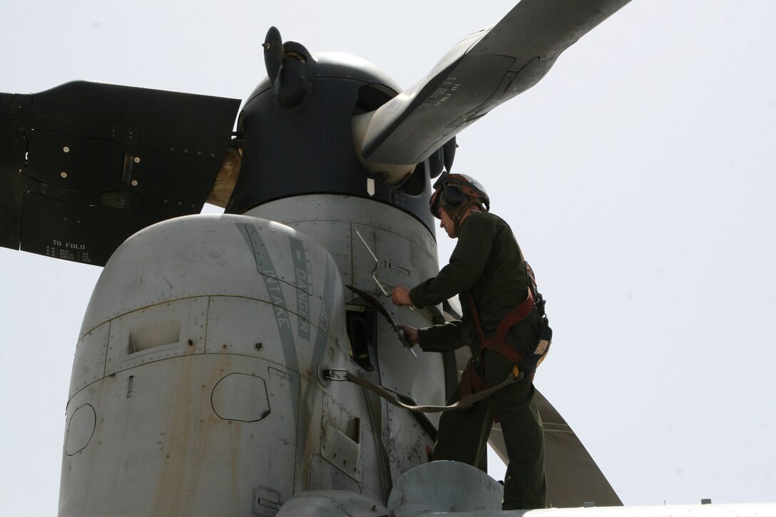 Sergeant Josiah M. Fox, a crew chief with Marine Medium Tiltrotor Squadron 261, works on an MV-22B Osprey in order to maintain the aircraft’s readiness aboard Camp Bastion, Helmand province, Afghanistan, April 5, 2014. The Marine Corps unit has the responsibility for being the first responders for casualty evacuations throughout the Regional Command (Southwest) area of operations.

