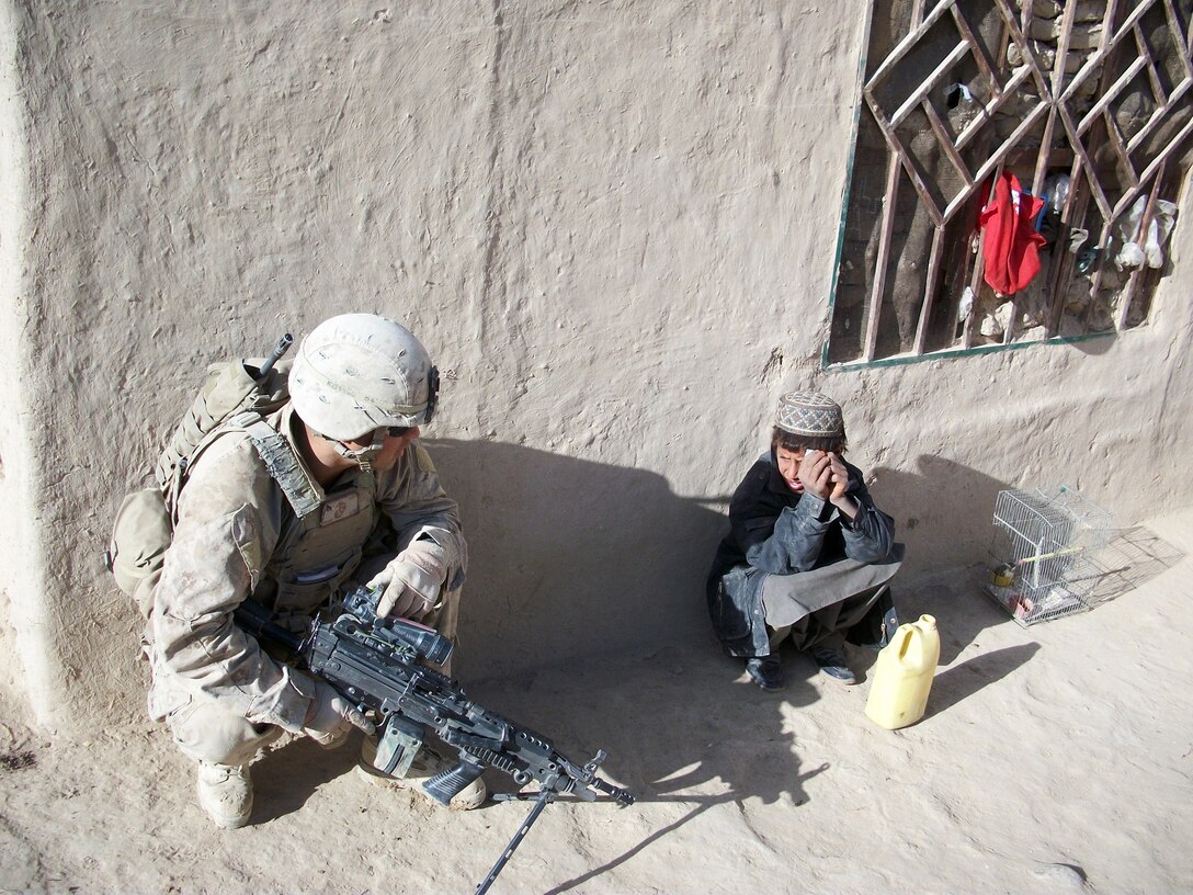 Sergeant Troy Garza, then a fire team leader with 3rd Battalion, 5th Marine Regiment, talks to an Afghan child during his first deployment to Sangin, Afghanistan, during 2010. During his first deployment in Sangin, the battalion sustained more than 200 Marines wounded in action and 28 Marines killed in action, which rendered them almost combat ineffective. Now Garza is deployed to Sangin again, this time as a squad leader with Charley Company, 1st Battalion, 7th Marine Regiment, and his mission is entirely different this time. The Afghans are now the lead element, and Charley Co. is preparing to transfer full security responsibilities to them.