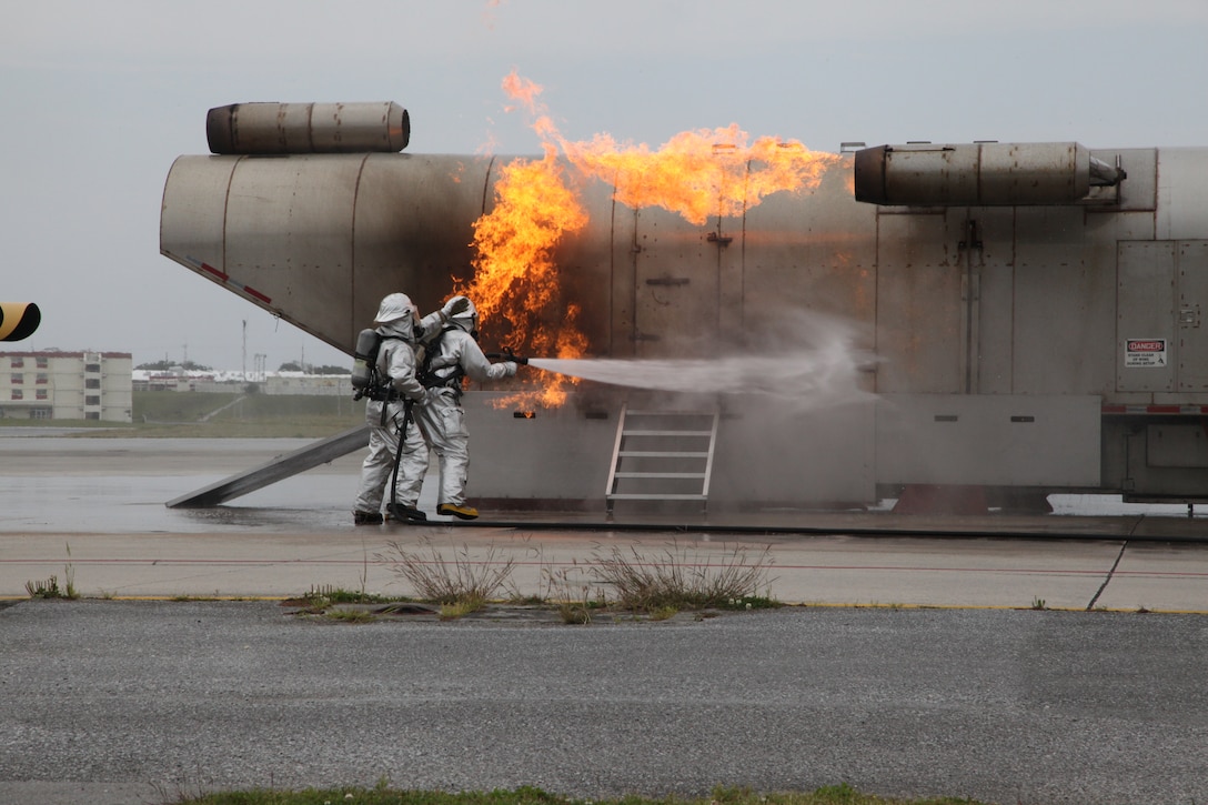 Marines put out a controlled fire on a mobile aircraft fire training device at Marine Corps Air Station Futenma April 7 during a visit from Girl Scouts. The firefighting display showed how the Marines respond to an emergency situation. The mission of Girl Scouts of America is to build the courage, confidence and character of girls, who can then make the world a better place, according to their website. The Marines are aircraft rescue and firefighting specialists with ARFF, Headquarters and Headquarters Squadron, MCAS Futenma, Marine Corps Installations Pacific. 