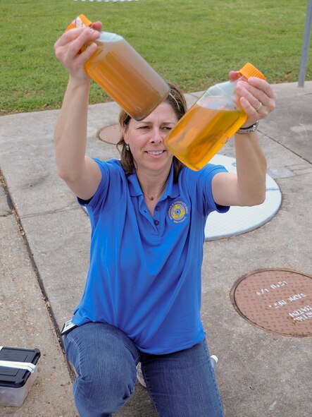 Dr. Wendy J. Goodson, Air Force Research Laboratory research biologist, compares two samples from a fuel tank on Barksdale Air Force Base, La., April 2, 2014. The samples will be analyzed by microscopy and DNA analysis. From this information, AFRL can begin to model the tank ecosystem, and begin to understand how the contaminants interact with the tank materials and each other. (U.S. Air Force photo/Staff Sgt. Jason McCasland)