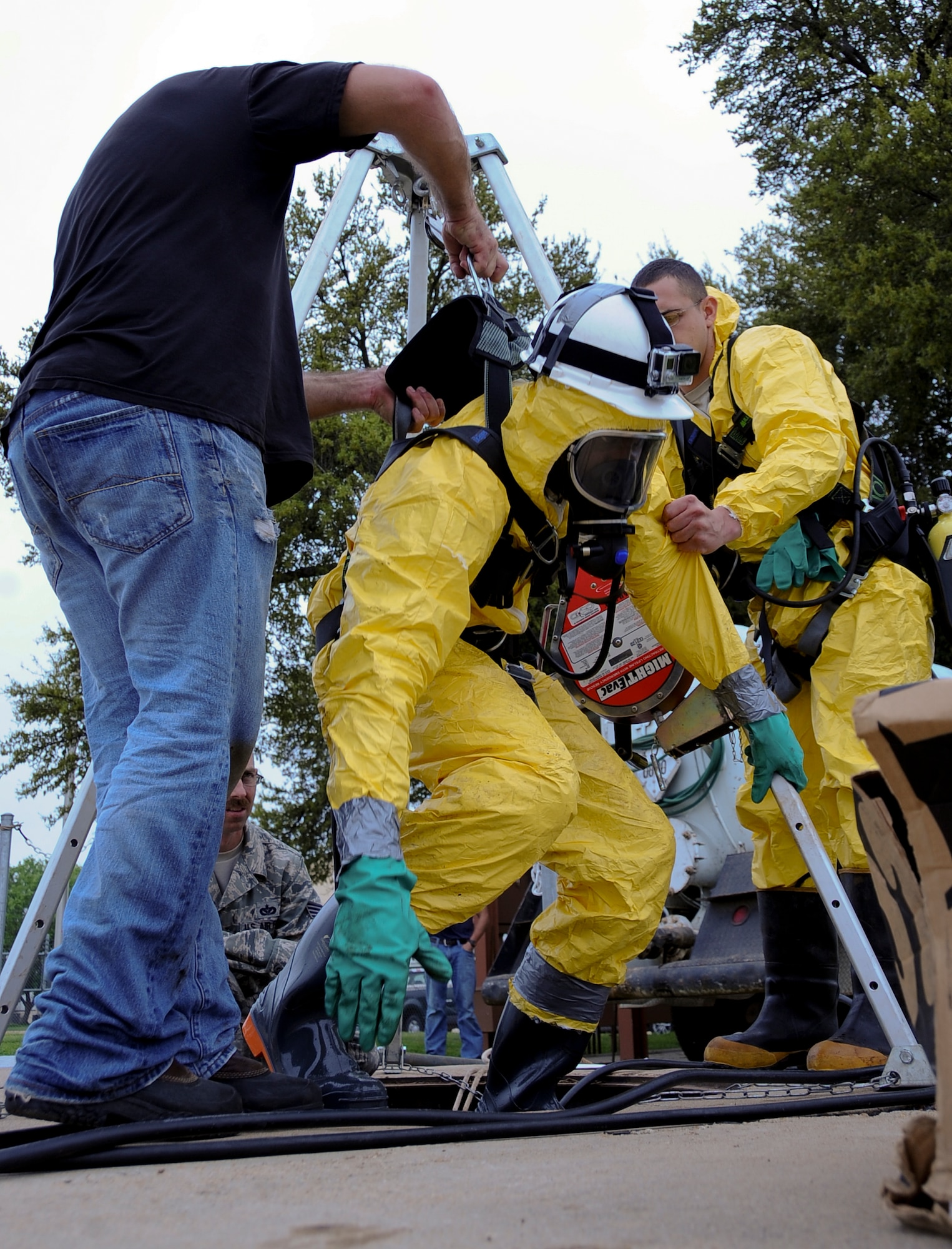 Members of the 2nd Civil Engineer Squadron liquid fuels shop, assist Senior Airman Jordan Taylor, 2nd CES liquid fuels technician, out of a biodiesel fuel tank on Barksdale Air Force Base, La., April 2, 2014. The fuel tank held more than 11,000 gallons of biodiesel that were removed prior to tank cleaning. The tank cleaning occurred after a fuel survey by the 2nd Logistics Readiness Squadron lab personnel discovered water and particulates in the tank. (U.S. Air Force photo/Staff Sgt. Jason McCasland)