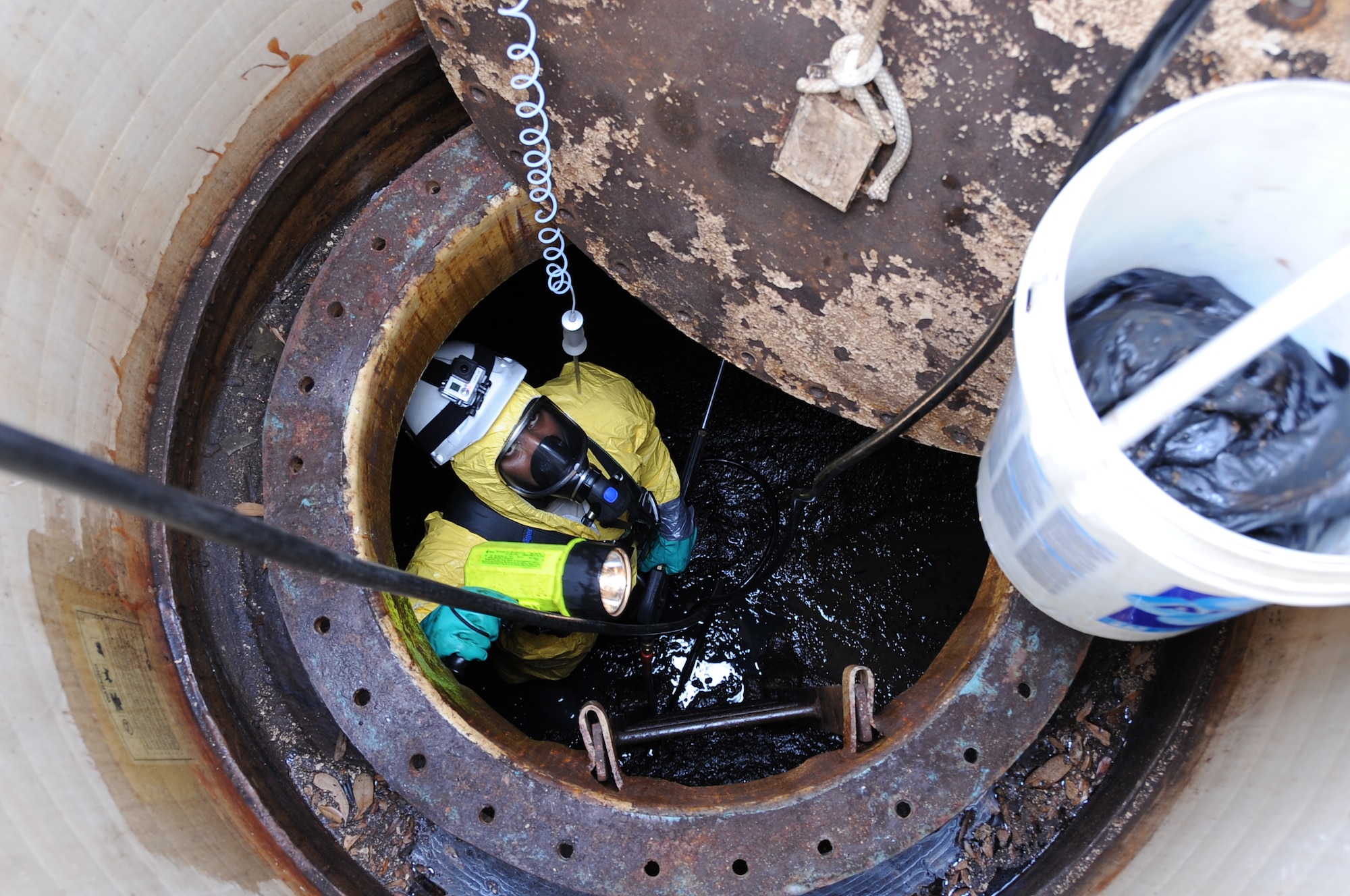 Senior Airman Jordan Taylor, 2nd Civil Engineer Squadron liquid fuels technician, waits for supplies to be lowered into a biodiesel fuel tank on Barksdale Air Force Base, La., April 2, 2014. Taylor entered the fuel tank to clean and sample contamination affecting the biodiesel used in more than 760 government vehicles on Barksdale.(U.S. Air Force photo/Staff Sgt. Jason McCasland)
