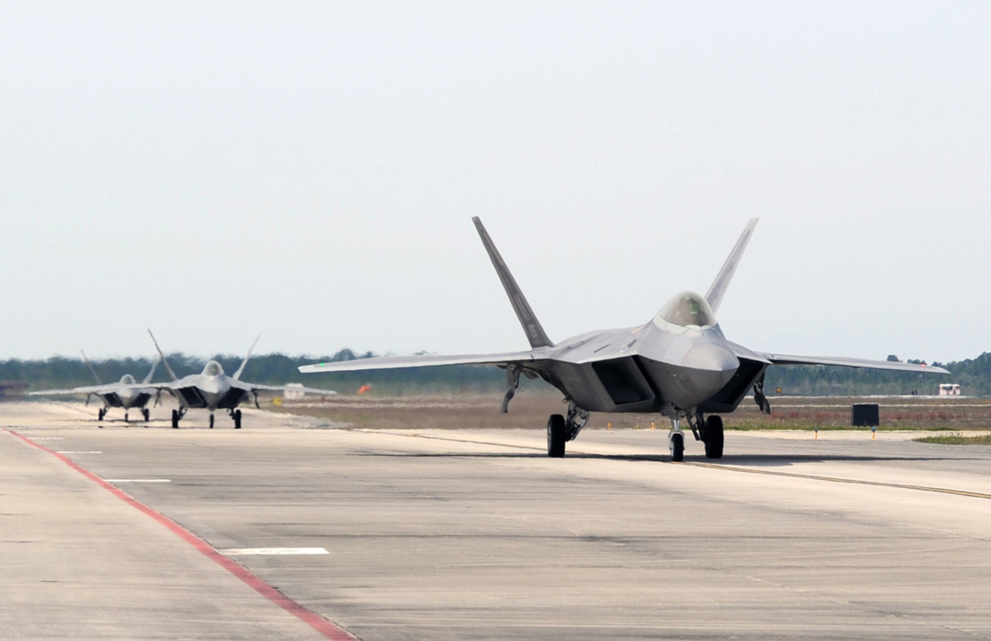 F-22s from the 90th Fighter Squadron at Joint Base Elmendorf-Richardson prepare for take-off on the flight line at Tyndall Air Force Base, Fla., during a Weapon Systems Evaluation Program March 26, 2014. The WSEP validates personnel, equipment and procedures. (U.S. Air Force photo/Master Sgt. Scott Wilcox)