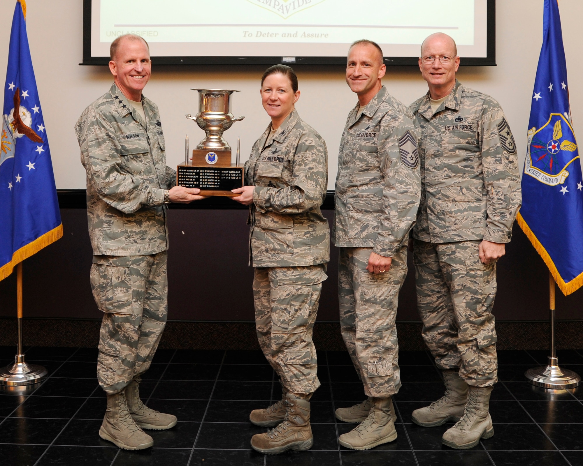 Lt. Gen. Stephen Wilson, Air Force Global Strike Command commander presents the Col. Lee R. Williams Memorial Award for Outstanding Missile Wing to Col. Tracey Hayes, 90th Missile Wing commander during a ceremony at Barksdale Air Force Base, April 9. The award is presented annually to the wing recognized as the best in their field. (U.S. Air Force photo/Senior Airman Joseph A. Pagán Jr.)