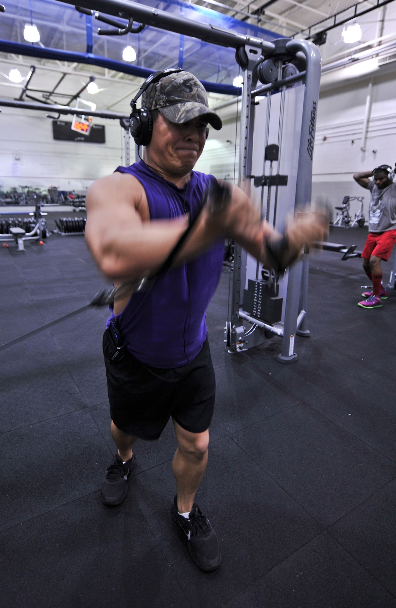 Senior Airman Jelani Acevedo-Morales, 1st Special Operations Security Forces Squadron Deployed Aircraft Ground Response Elements team member, does cable flys at the Commando Fitness Center on Hurlburt Field, Fla., April 7, 2014. Active duty, Guard, Reserve, and DoD civilian common access cardholders can apply for after-hours gym access at the customer service counter during normal business hours. (U.S. Air Force photo/Staff Sgt. John Bainter)