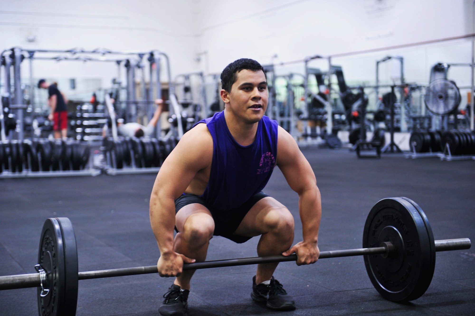 Senior Airman Jelani Acevedo-Morales, 1st Special Operations Security Forces Squadron Deployed Aircraft Ground Response Elements team member, prepares for a clean and jerk at Hurlburt Field, Fla., April 7, 2014. Common access cardholders can use the gym after-hours once they sign a statement of understanding, which outlines the program rules.
 (U.S. Air Force photo/Staff Sgt. John Bainter)
