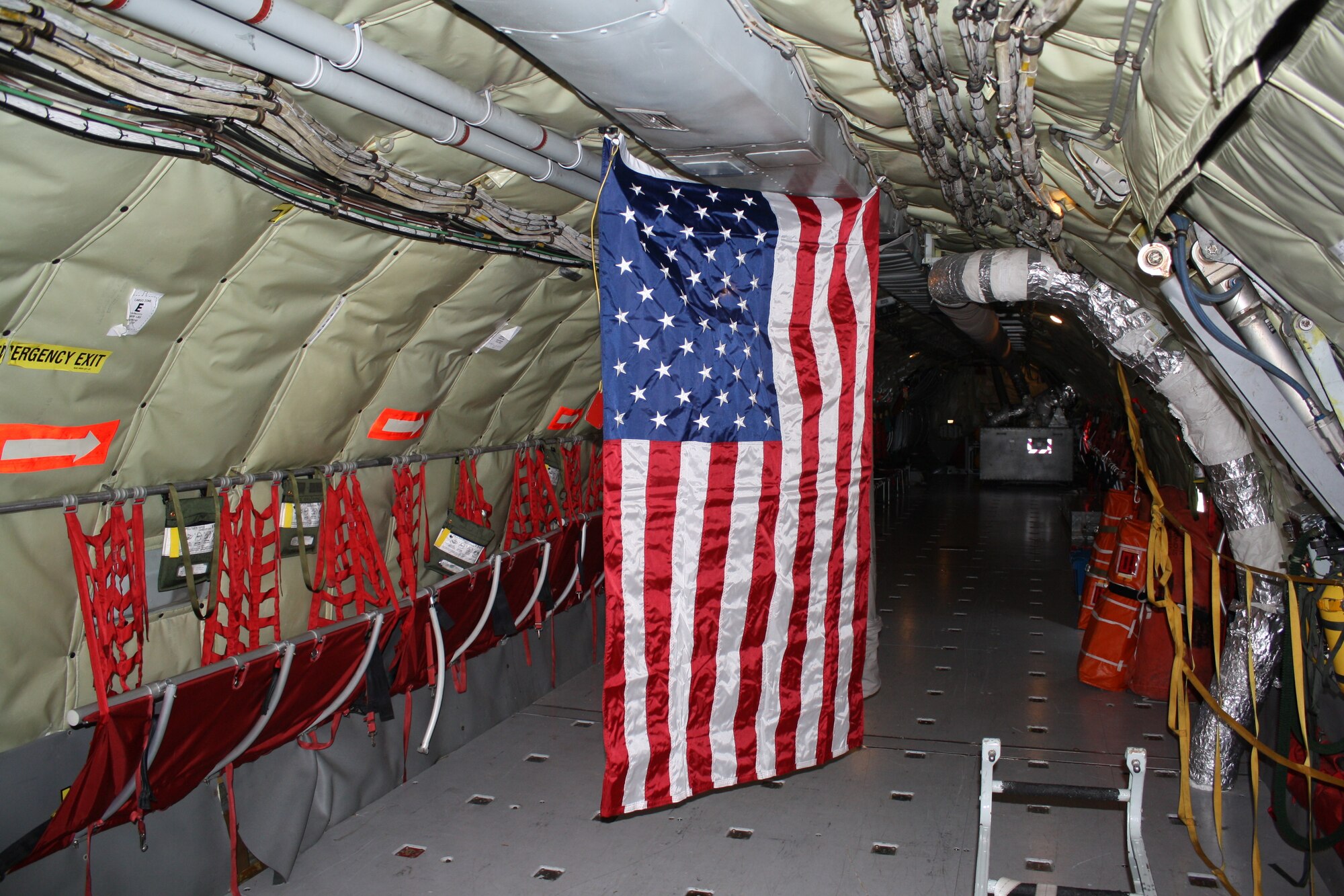An American flag hangs inside of a KC-135 Stratotanker during a flyover in honor of Maj. Gen. Alfred Stewart, former Air Force Personnel Center Commander, March 25, at San Antonio, Texas. Stewart, a squarepatch alumni requested that the 384th perform a flyover at his funeral in the event of his passing. (courtesy photo)