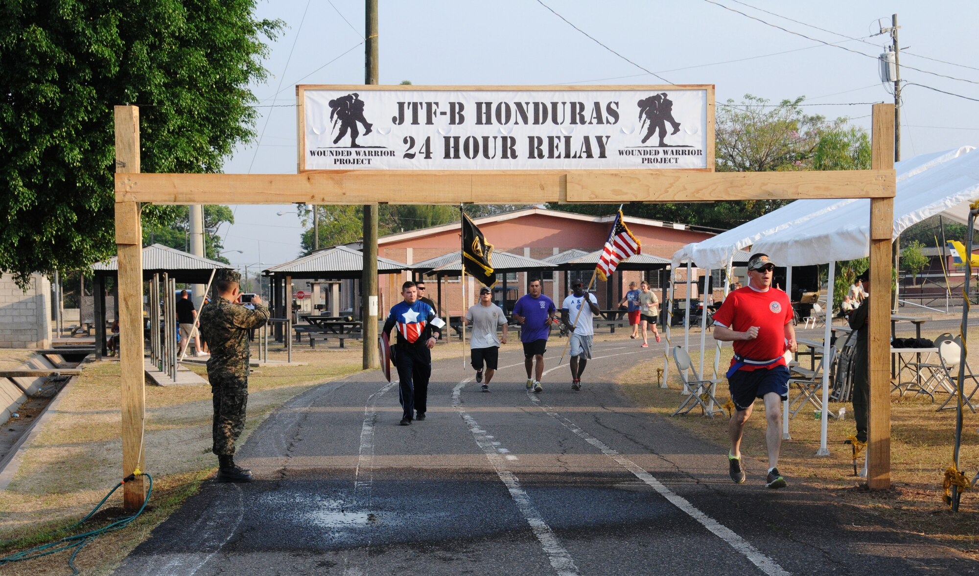 Service members show their patriotism by carrying the American flag in honor of their fallen brothers and sisters in service. Service members from Joint Task Force-Bravo and the Honduran Air Force Academy participated in the 2nd Annual JTF-Bravo Wounded Warrior Project 24-hour relay April 4-5, 2014 at Soto Cano Air Base, Honduras. Nineteen teams consisting of 4, 6, 8 or 12 members ran or walked almost 2,180 miles to remember their injured brothers and sisters in service and to raise funds for the Wounded Warrior Project. A total of $6,000 has been raised by this event so far with more funds expected to be received. (Photo by U. S. Air National Guard Capt. Steven Stubbs)