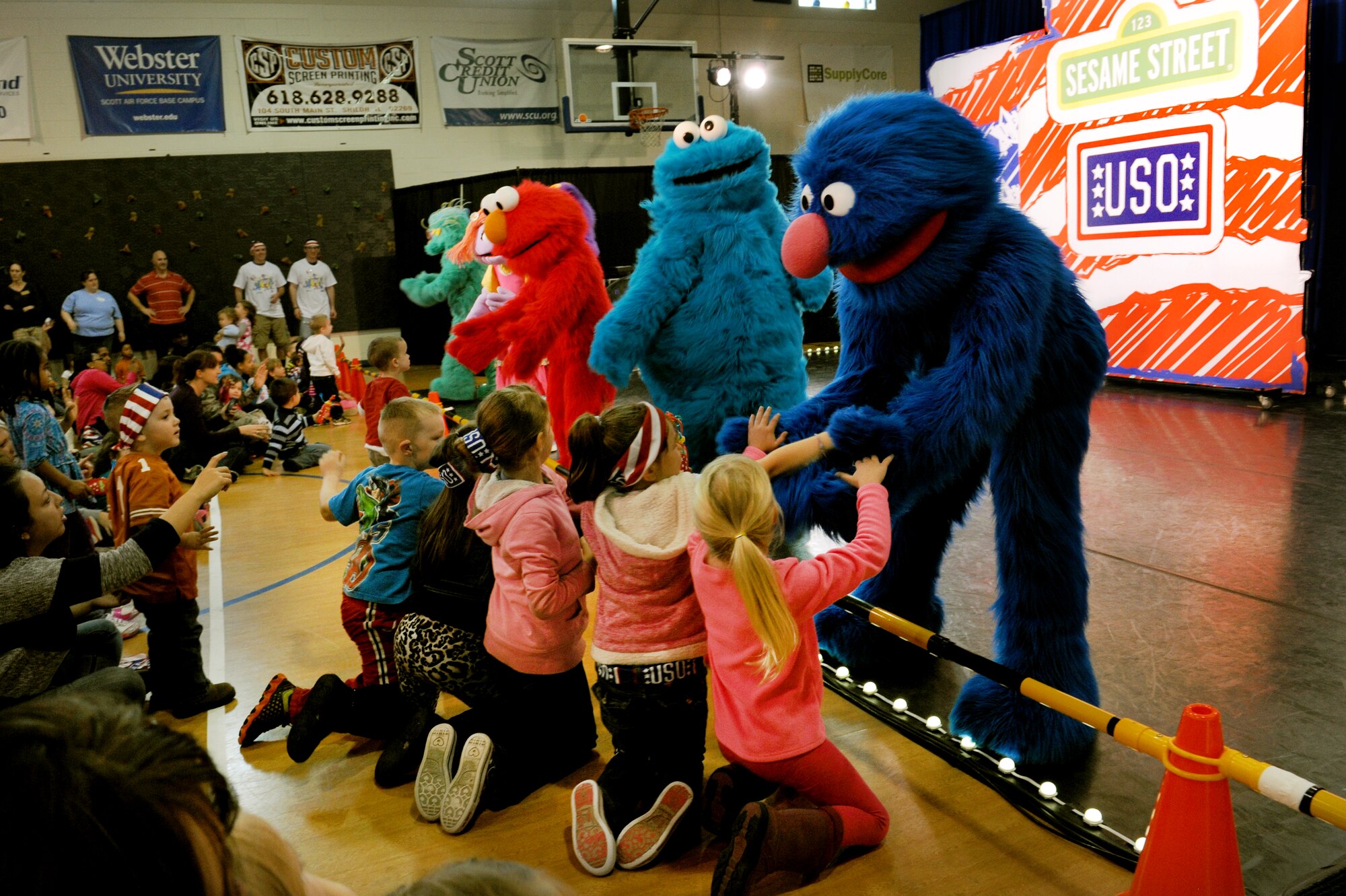 Characters greet children during the Sesame Street/USO tour stop at Scott Air Force Base. (U.S. Air Force photo/ Airman 1st Class Megan Friedl)