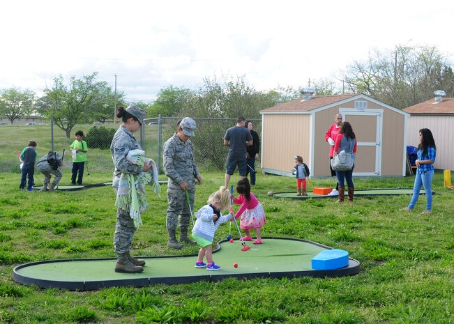 Team Beale participate in a round of putt-putt golf during the Children’s Spring Carnival at the Youth Center on Beale Air Force Base, Calif., April 4, 2014. The event also offered free pizza, popcorn, cotton candy and cupcakes. (U.S. Air Force photo by Senior Airman Allen Pollard/Released) 