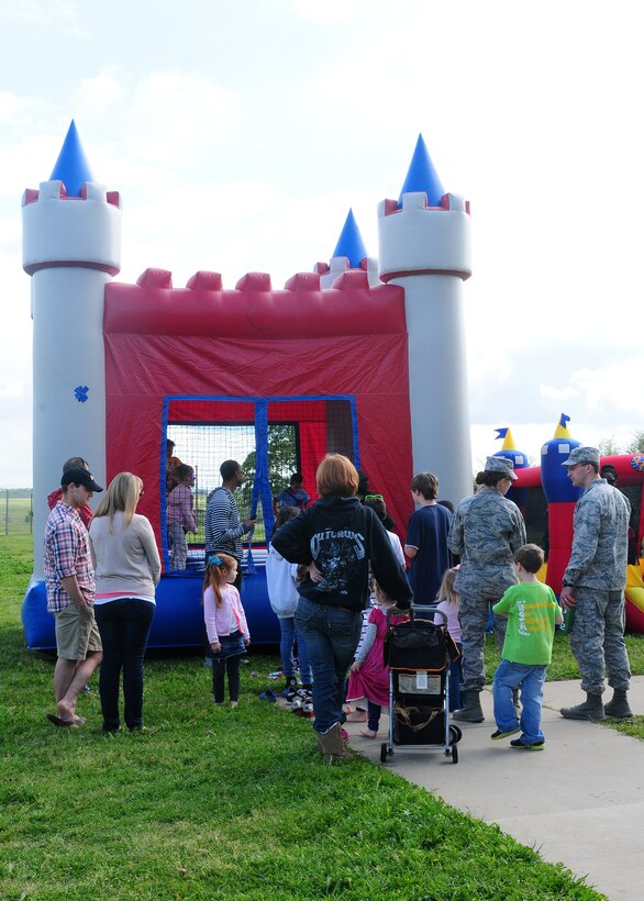 Beale youth jump in the bounce house during the Children’s Spring Carnival at the Youth Center on Beale Air Force Base, Calif., April 4, 2014. The event featured a rock climbing wall, putt-putt golf, mini games, face painting, food, treats and prizes. (U.S. Air Force photo by Senior Airman Allen Pollard/Released)