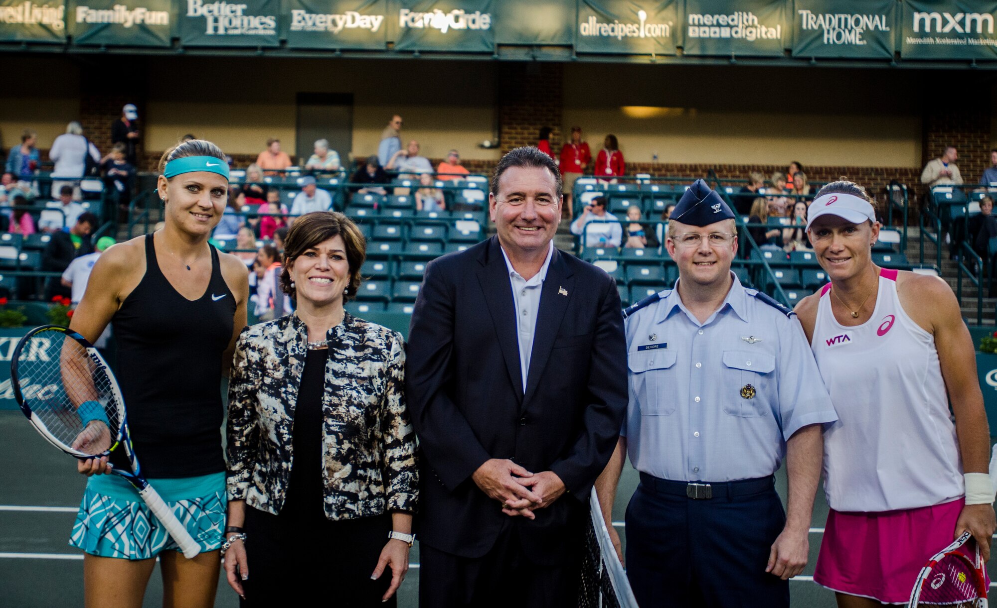 Col. Jeffrey Devore, Joint Base Charleston commander, provides support for the opening ceremonies at the Family Circle Cup Tennis Tournament on Military Appreciation Night April 3, 2014, at the Family Circle Cup stadium on Daniel Island, S.C. Along with Devore are representatives from the Family Circle Cup and professional tennis players, (far left) Lucie Safarova and Samantha Stosur (right). (U.S. Air Force photo / Senior Airman Tom Brading)