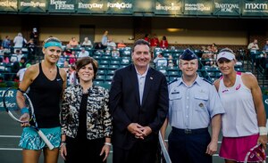 Col. Jeffrey Devore, Joint Base Charleston commander, provides support for the opening ceremonies at the Family Circle Cup Tennis Tournament on Military Appreciation Night April 3, 2014, at the Family Circle Cup stadium on Daniel Island, S.C. Along with Devore are representatives from the Family Circle Cup and professional tennis players, (far left) Lucie Safarova and Samantha Stosur (right). (U.S. Air Force photo / Senior Airman Tom Brading)