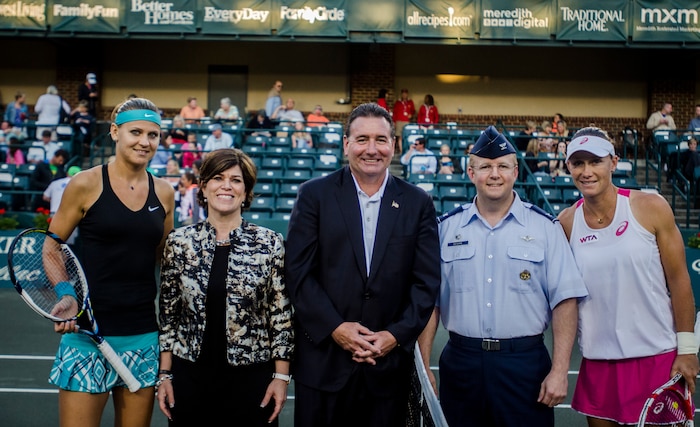 Col. Jeffrey Devore, Joint Base Charleston commander, provides support for the opening ceremonies at the Family Circle Cup Tennis Tournament on Military Appreciation Night April 3, 2014, at the Family Circle Cup stadium on Daniel Island, S.C. Along with Devore are representatives from the Family Circle Cup and professional tennis players, (far left) Lucie Safarova and Samantha Stosur (right). (U.S. Air Force photo / Senior Airman Tom Brading)