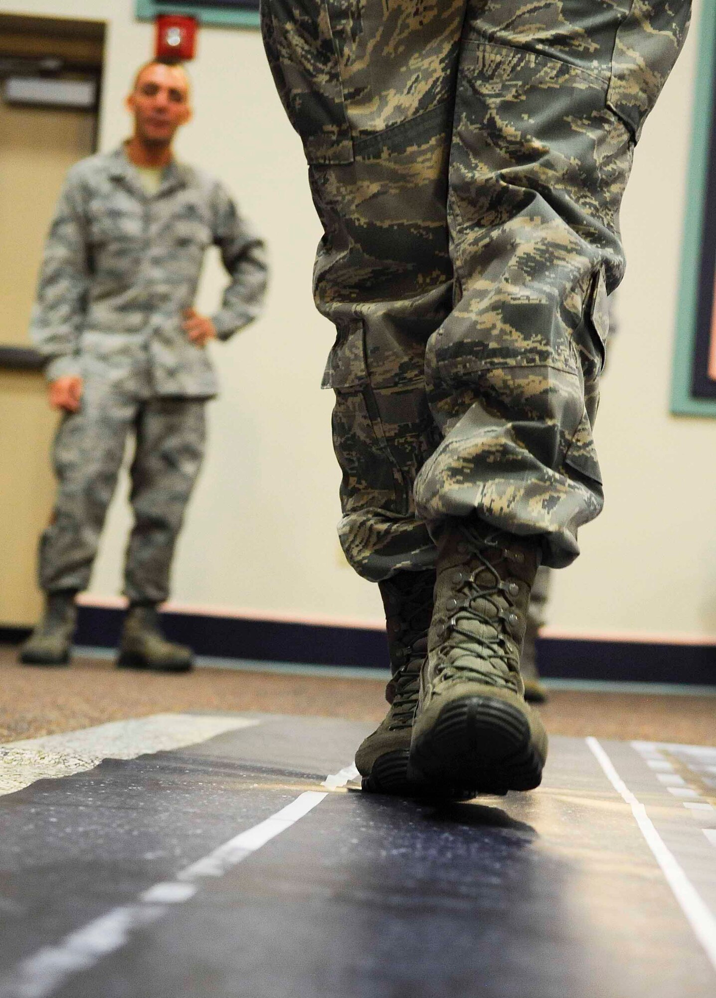 An Airman attempts to walk a straight line while wearing fatal vision goggles on Hurlburt Field, Fla., April 9, 2014. Most participants couldn’t stay on the line while wearing the goggles. (U.S. Air Force photo/Airman 1st Class Andrea Posey)