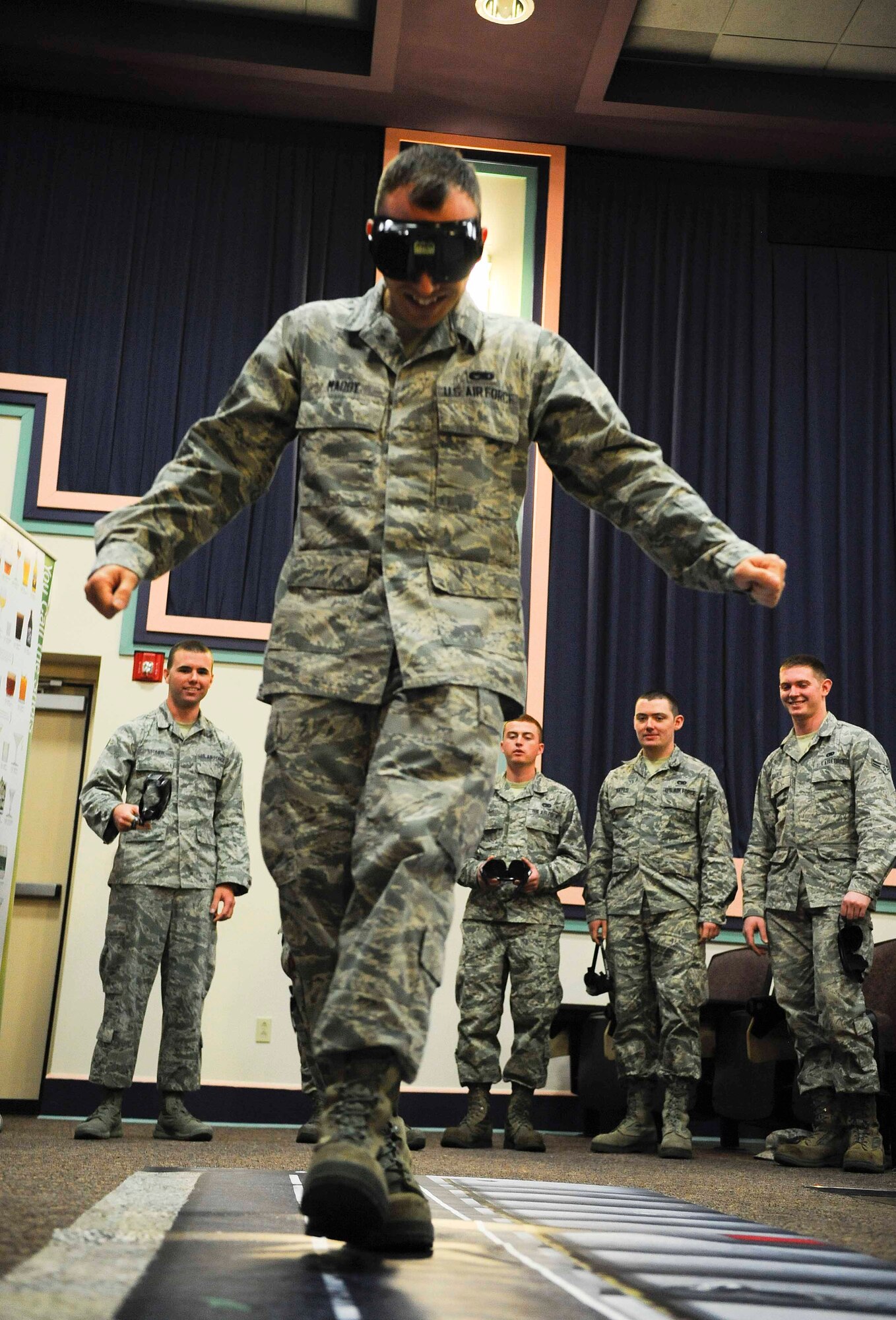 Airman 1st Class John Maddy, 1 Special Operations Component Maintenance Squadron aerospace propulsion journeyman, walks a line while wearing fatal vision goggles on Hurlburt Field, Fla., April 9, 2014. Fatal vision goggles simulate how alcohol can impair an individual’s senses. (U.S. Air Force photo/Airman 1st Class Andrea Posey)