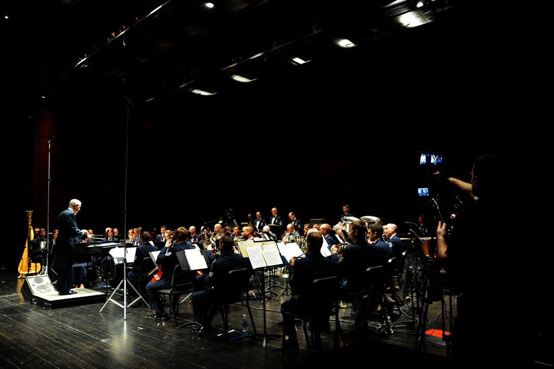 Chief Master Sgt. Jebodiah Eaton records The U.S. Air Force Band’s permanence at Monroe Community College in Monroe, Mich., April 8, 2014. The bandsmen prepared two destination-themed programs for the tour, including opera and Broadway vocal features,as they travel through three Midwestern states. Eaton is also the Band's production chief. (U.S. Air Force photo/Master Sgt. Tammie Moore)