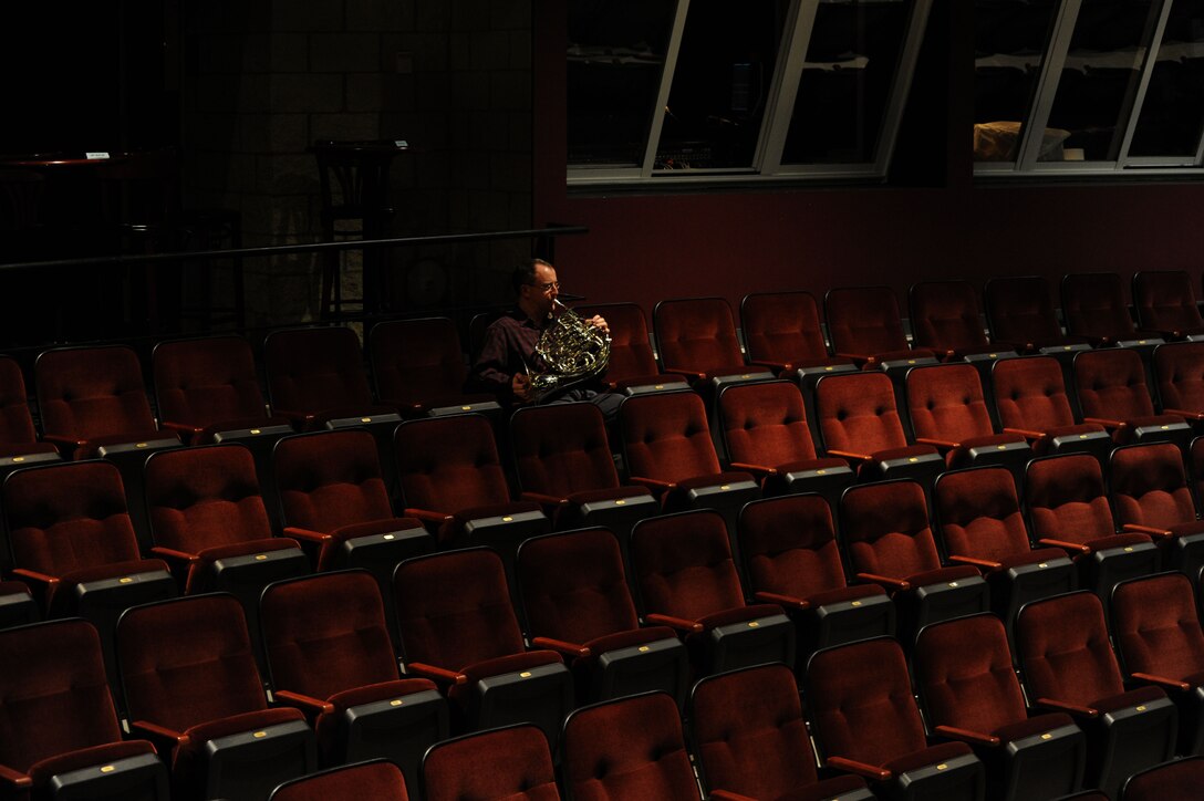 Senior Master Sgt. Kent Wyatt practices before The U.S. Air Force Band takes the stage at Monroe Community College in Monroe, Mich., April 8, 2014. Wyatt, a native of Arlington, Texas, is a french hornist with the Concert Band, the largest ensemble of the Band. The bandsmen are midway through their 2014 spring tour featuring the Concert Band and Singing Sergeants, the official chorus of the U.S. Air Force. (U.S. Air Force photo/Master Sgt. Tammie Moore)