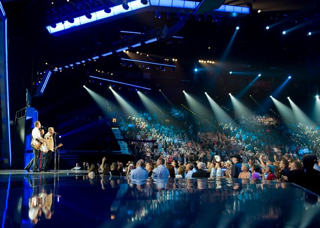 U.S. Marine Corps Staff Sgt. Brandon Valentine, a radio operator stationed at Marine Corps Air Ground Combat Center 29 Palms, Calif. performs with Rascal Flatts at the Academy of Country Music’s An All-Star Salute to the Troops at the MGM Grand April 7, 2014, in Las Vegas. The service members performed with Lady Antebellum, Lee Brice, Toby Keith, The Band Perry, Keith Urban, Hunter Hayes, Rascal Flatts, and Kellie Pickler. (U.S. Air Force photo by Senior Airman Jason Couillard)