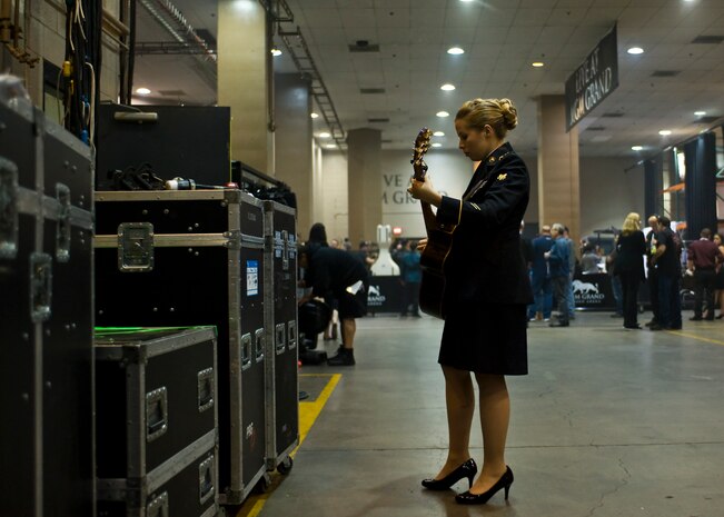 U.S. Army Spc. Kelly Gregg, a patient administration specialist assigned to Fort Bliss, Texas practices on her guitar before her performance with The Band Perry April 7, 2014, at the MGM Grand in Las Vegas. All of the military services afforded their members a chance to perform with a country music celebrity, and nine service members were given that opportunity. (U.S. Air Force photo by Senior Airman Jason Couillard)