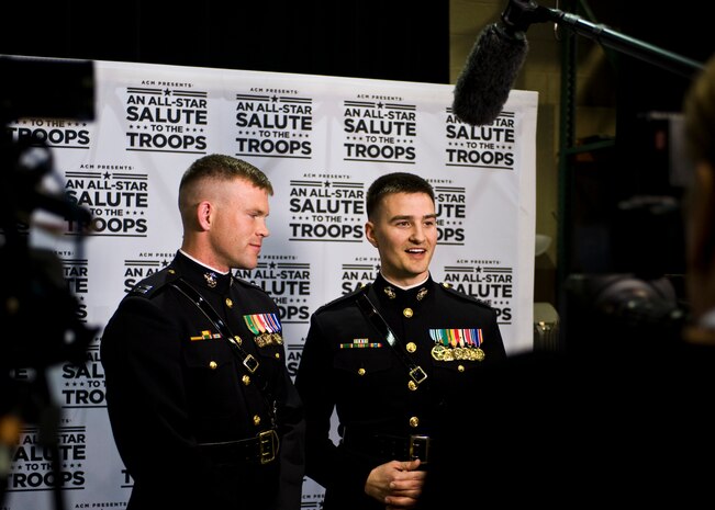 U.S. Marine Corps Capt. John Auer, Silent Drill Platoon commander assigned to the Marine Barracks in Washington, D.C., and U.S. Marine Corps Capt. Matt Smith, assistant operations officer assigned to the Marine Barracks in Washington, D.C. are interviewed by Entertainment Tonight at the Academy of Country Music’s An All-Star Salute to the Troops at the MGM Grand April 7, 2014, in Las Vegas.  Auer and Smith performed with Lady Antebellum. Smith played the guitar and Auer played the fiddle. (U.S. Air Force photo by Senior Airman Jason Couillard)