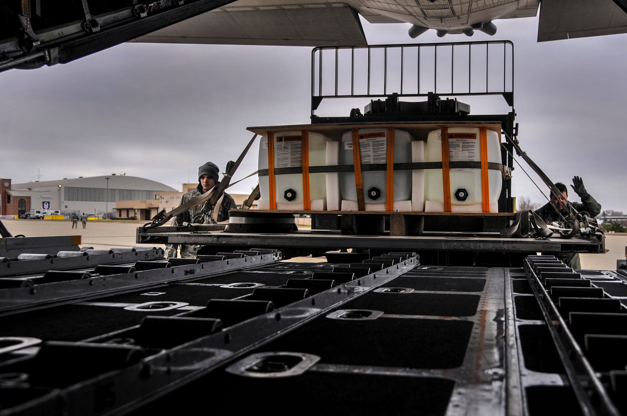 Members of the 32nd Aerial Port Squadron load an equipment pallet onto the back of a C-130 Hercules with a 10K loader at the Pittsburgh International Airport Air Reserve Station, April 5, 2014. The equipment was used as part of an exercise to simulate food and water that is dropped from the back of the plane when it touches down during a combat drop. (U.S. Air Force photo by Senior Airman Joshua J. Seybert)