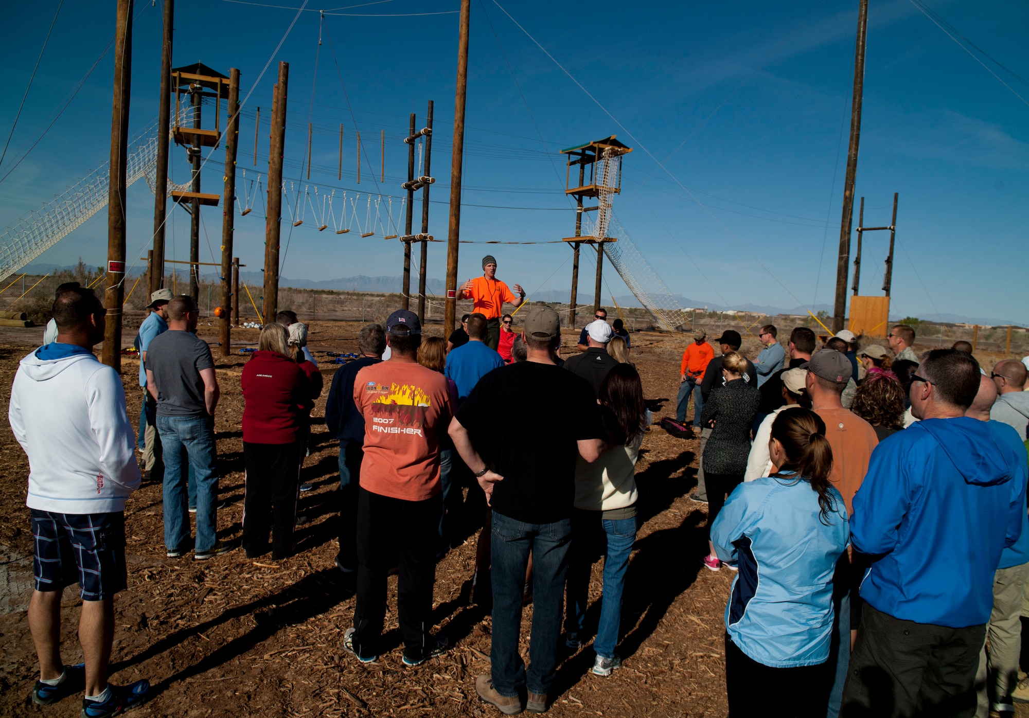 Ted Brinegar, 49th Wing community support coordinator, introduces members of Team Holloman leadership and their families to the newly built Ropes Course at Holloman Air Force Base, N.M., March 29. Members of Team Holloman leadership and their families were introduced to the new Ropes Course as a team building exercise and to showcase all of the possible activities available on the course. (U.S. Air Force photo by Airman 1st Class Aaron Montoya / Released)