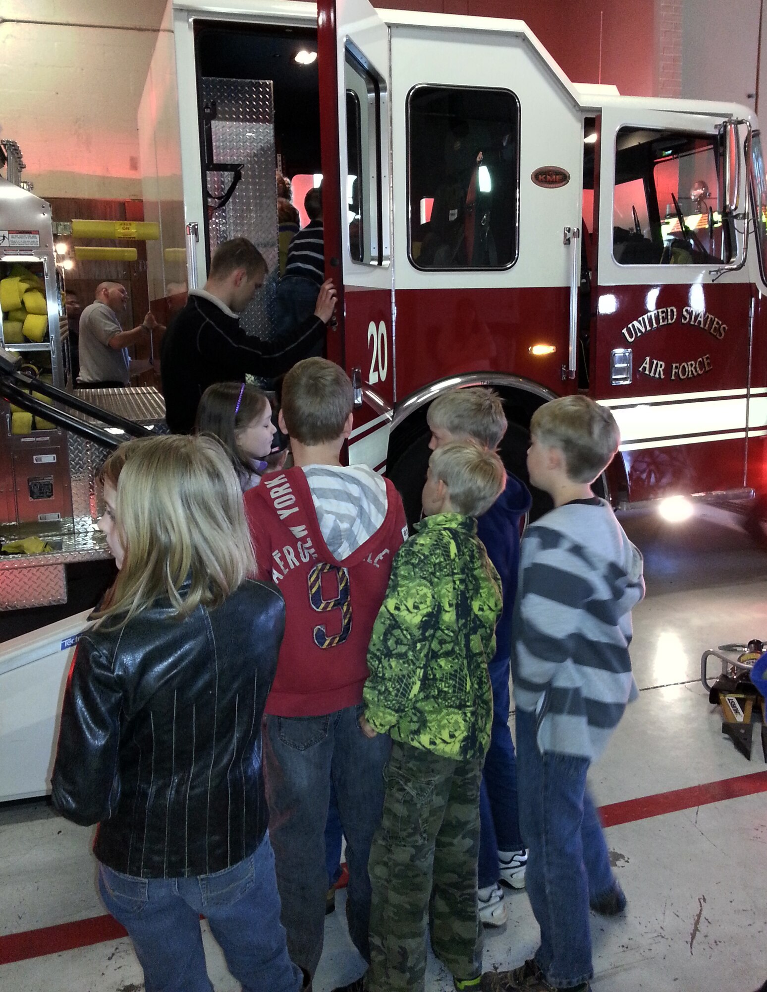 Josh McKay, a full-time state employee with the 188th Fire Department, gives members of the Believers Home School Group a tour of a fire truck April 9, 2014. Approximately 115 members of the group also toured the 188th Security Forces Squadron and A-10 static display. The group also received a mission briefing on the 188th’s on-going conversion from fighters to an Intelligence, Reconnaissance and Surveillance, space-focused targeting and remotely piloted aircraft mission.  (U.S. Air National Guard photo by Maj. Heath Allen/Released)