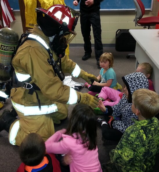Senior Airman Jordan Wiley, a drill status Guardsman with the 188th Security Force Squadron and a full-time state employee with the 188th Fire Department, dons his protective fire suit during a base tour April 9, 2014.   Approximately 115 members of the Believers Home School Group also toured the 188th Security Forces Squadron and A-10 static display. The group also received a mission briefing on the 188th’s on-going conversion from fighters to an Intelligence, Reconnaissance and Surveillance, space-focused targeting and remotely piloted aircraft mission.  (U.S. Air National Guard photo by Maj. Heath Allen/Released)