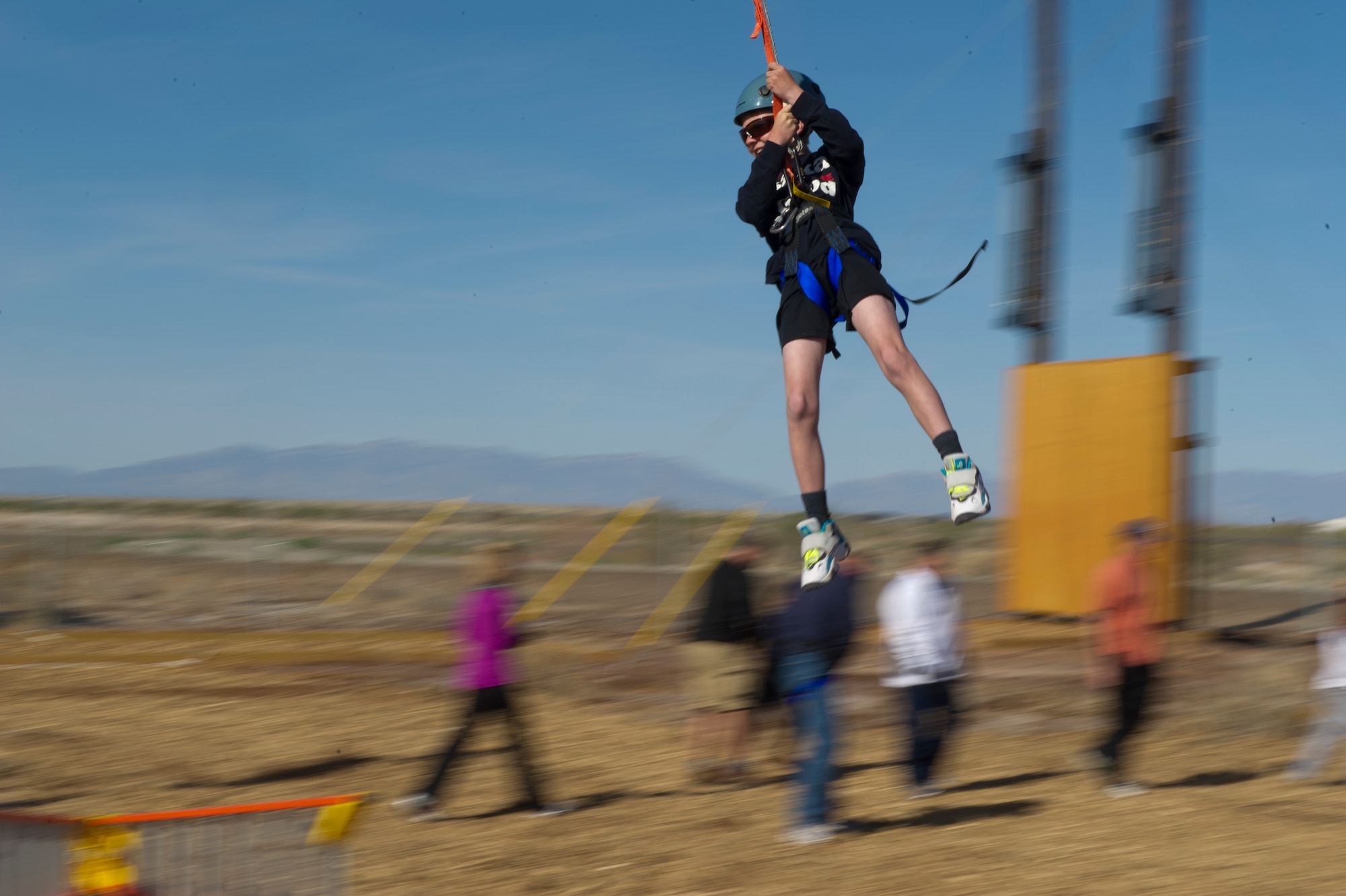 A Team Holloman dependent swings through the air at Holloman Air Force Base, N.M., March 29. Members of Team Holloman leadership and their families were introduced to the new Ropes Course as a team building exercise and to showcase all of the possible activities available on the course. (U.S. Air Force photo by Airman 1st Class Aaron Montoya / Released)