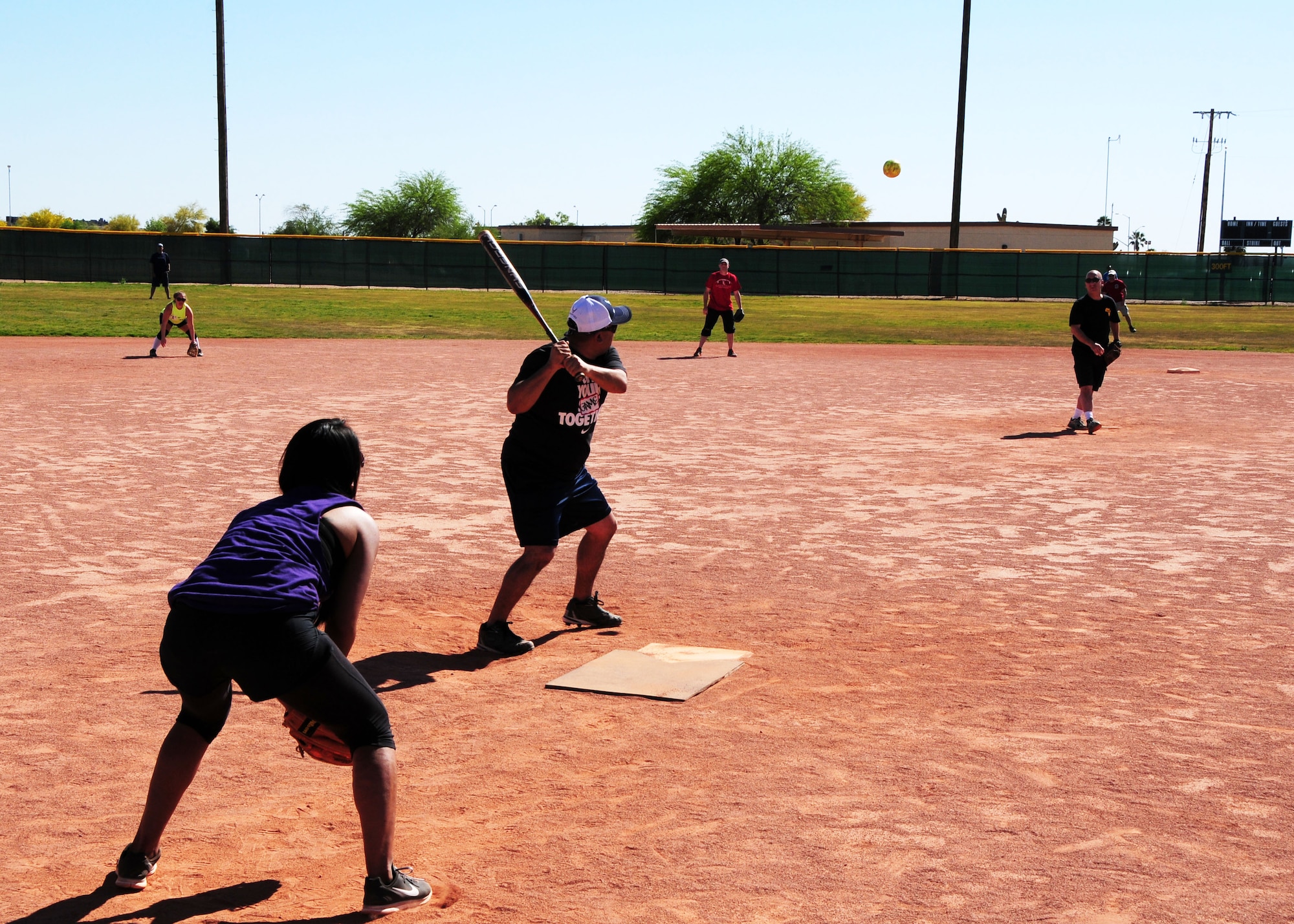 Tech. Sgt. Ricardo Rodriguez, 944th Medical Squadron medical technician, prepares to hit a ball pitched by Col. Curtiss Cook, 944th Aeromedical Staging Squadron Commander, April 6 during a friendly softball game between the 944th Medical Squadron and the 944th Aeromedical Staging Squadron at Luke Air Force Base, Ariz. (U.S. Air Force photo taken by Tech. Sgt. Louis Vega Jr.)