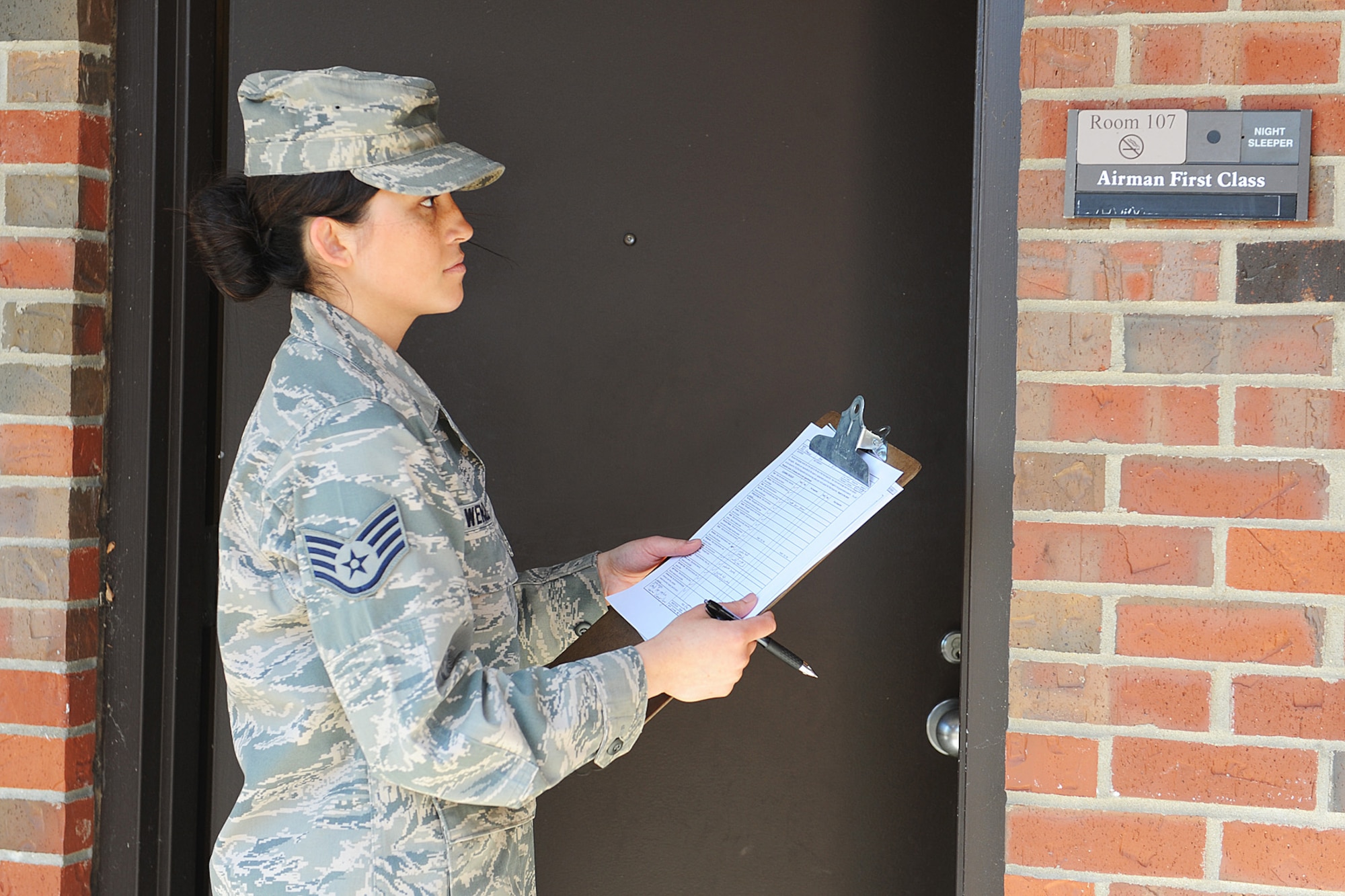 Staff Sgt. Erika Wenzel enters room 107 to do an inspection at Scott Air Force Base. When a dorm resident moves out of their room, the room must be cleaned and receive a passing inspection. Wenzel is an Airman dormitory leader assigned to the 375th Civil Engineer Squadron. (U.S. Air Force photo/ Staff Sgt. Maria Bowman)