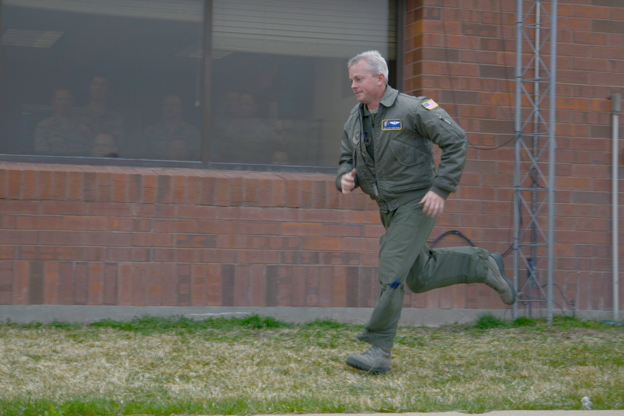 Master Sgt. Kurt Armstrong runs to the flight line following an alert given during an exercise April 6, 2014. (Air National Guard photo by Tech. Sgt. Kelly Collett/RELEASED)