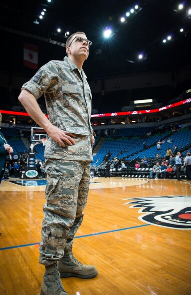 Staff Sgt. Trevor Saylor, 934th Airlift Wing Public Affairs, stands at center court during a Minnesota Timberwolves pregame ceremony.  Saylor was recognized for his service in the Air Force Reserve as part of the Timberwolves Heroes United program to thank Minnesota military members for their service. (Air Force Photo/Keith Langsdorf)